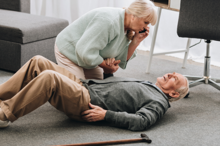 A wife helping her husband who has fallen while calling for help.